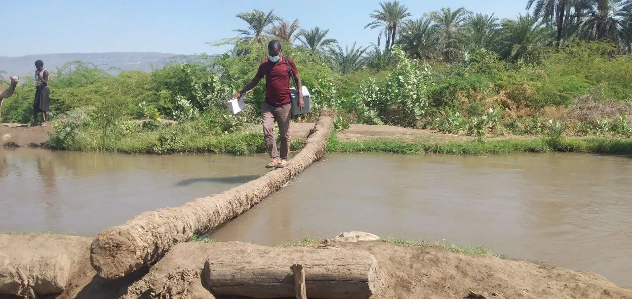 man crosses river in Ethiopia